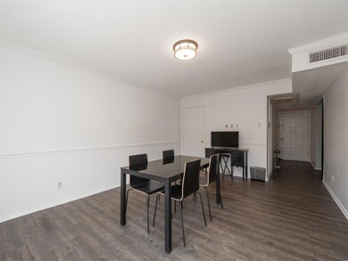 Dining space featuring dark wood-type flooring and