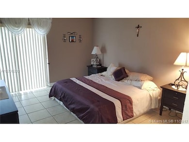 14.5' x 12' tiled Master bedroom with sliding glas
