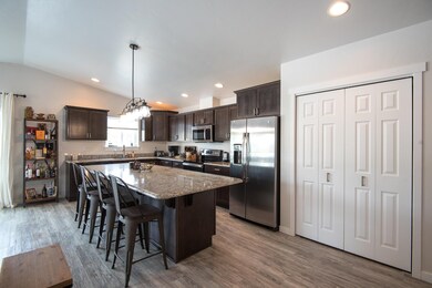 Large open kitchen featuring granite cou