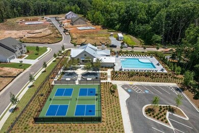 Aerial view featuring a wooded view