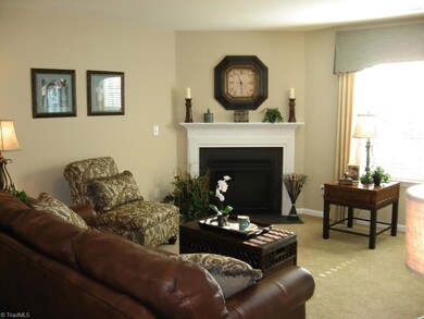 Living room with gas fireplace: image similar to finished home.