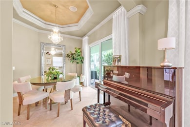 Dining room with a chandelier, light tile patterne