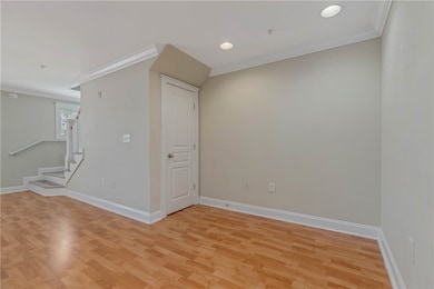 Empty room featuring ornamental molding, baseboard