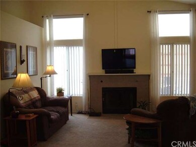 The living room features a cozy wood burning or ga