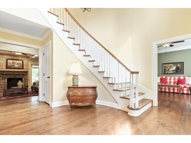 Grand front entry with wood curving staircase open