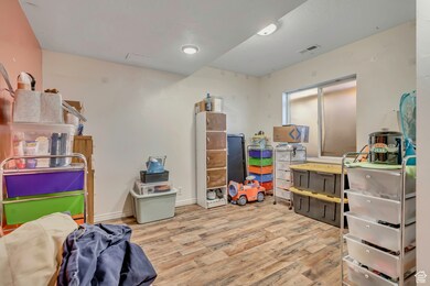 Recreation room featuring light wood finished floors and baseboards