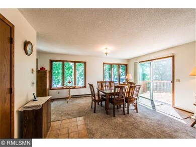 Bright dining area offers views of the lake and wi