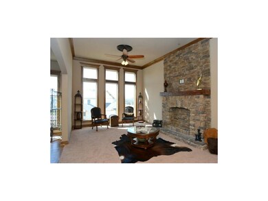 living room with stone, gel-burning fireplace