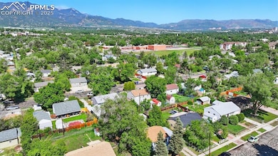 Aerial view of home and neighborhood with mountain views in the backgroud.
