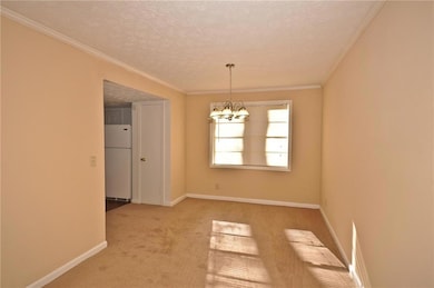 Carpeted spare room with crown molding, a notable 