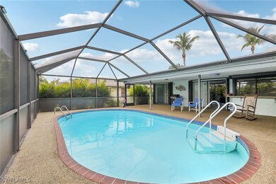 View of swimming pool featuring a patio area, glass enclosure, and ceiling fan