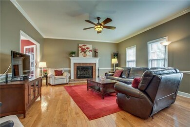 Wood Burning fireplace in Family Room.  Moldings and beautiful hardwood floors.