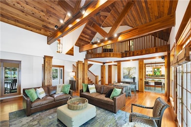 Living area featuring beamed ceiling, wood finishe