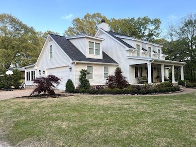 View of front of property with a front lawn, drive