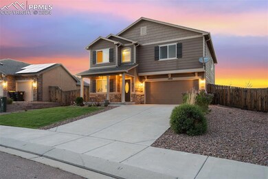 Craftsman house with a yard and solar panels