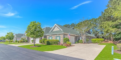 View of front of home with concrete driveway, bric
