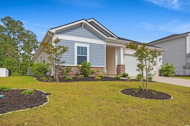 Craftsman-style house with concrete driveway, a fr