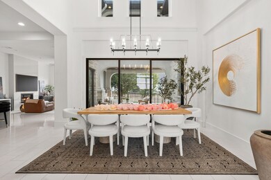 Tiled dining room featuring a glass covered firep