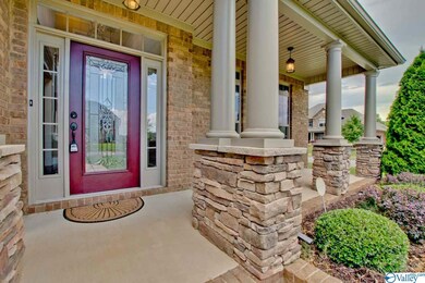 accent the columns and front facade, while the decorative glass front door with transoms is a dazzling pop of color.
