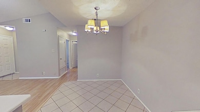 Empty room with visible vents, baseboards, light 