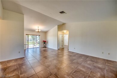 View from front door reveals 18 X 18” tile floors throughout main living area-living room, dining room, kitchen. Vaulted ceiling makes home feel larger than the square footage.