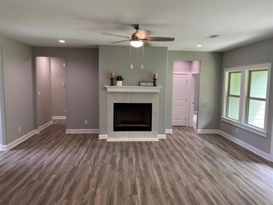 Unfurnished living room featuring dark hardwood / 