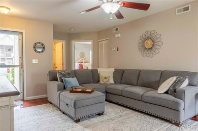 Living room featuring wood finished floors and a ceiling fan