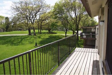 The deck looks out on expansive lawn and mature tr
