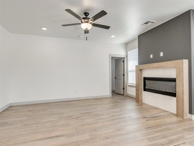Unfurnished living room featuring a tile fireplace