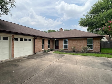 extended double-wide driveway leads to 2-car garage