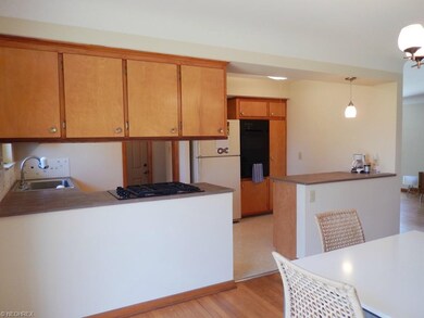 Kitchen with wood cabinetry and appliances.