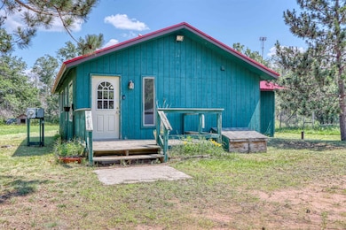 View of front of home featuring a front yard and a wooden deck