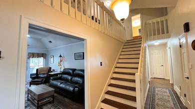 Staircase featuring lofted ceiling, wood-type floo