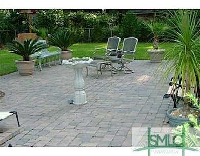 Exterior Back. Over 700 SF of brick pavers makes a