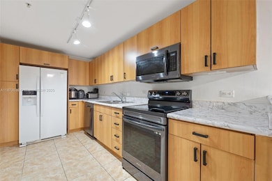 Updated kitchen with stainless steel appliances, granite countertops, and wood cabinetry — perfect for home chefs.