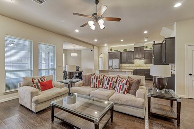 The living area is open to the kitchen and breakfast room with views of the back yard.