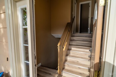 Staircase featuring wood finished floors