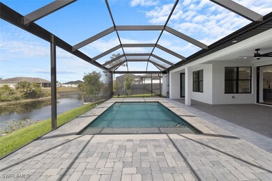 Pool with a water view, a patio area, glass enclos