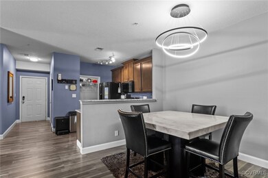 Dining room featuring dark wood-style floors, base