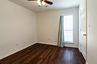 Empty room featuring dark hardwood / wood-style fl