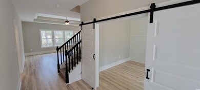 Staircase featuring hardwood / wood-style flooring
