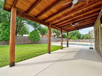 Look at the quality of this outdoor covered patio with mounted TV.