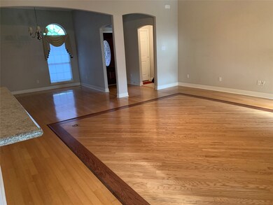 A view of the dining room, living room.front door entry,and door the the garage from the breakfast area. You'll have lots of space here.