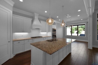 Kitchen featuring custom exhaust hood, white cabin