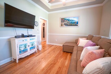 Den/Dining Room featuring crown molding, a ceiling