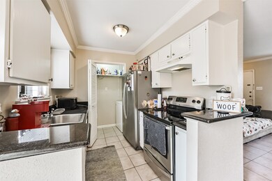 The kitchen features tile floors, granite counters