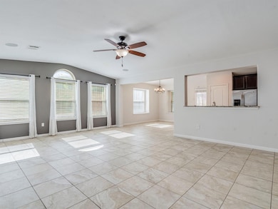 Unfurnished living room with vaulted ceiling, lig