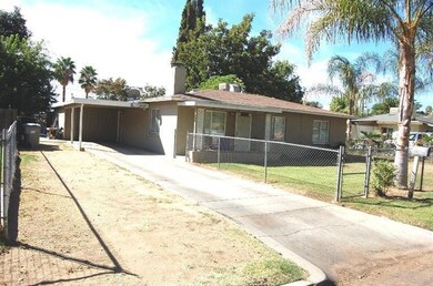 Shows East side view and car port.