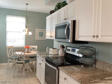 Kitchen with white cabinets, plenty of natural lig
