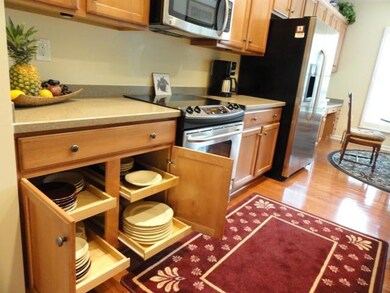 Functional kitchen with slide outs and hardwood floors! Desk area with upper cabinets, upgraded knobs on all cabinets, Pantry Built-ins by California Closets and Kholer sink fixture. 